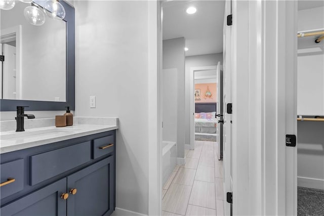 bathroom with vanity and independent shower and bath