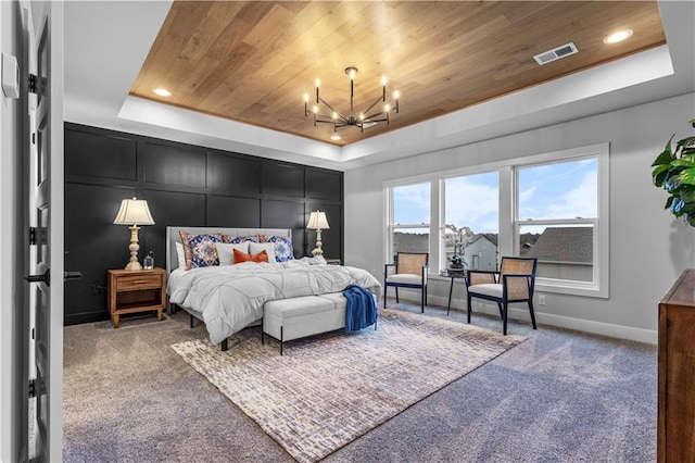 carpeted bedroom featuring a notable chandelier, a raised ceiling, and wooden ceiling