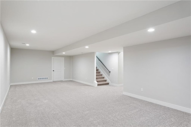 basement featuring light colored carpet