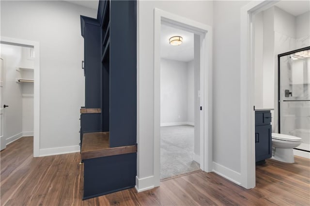 hall with dark wood-type flooring and baseboards