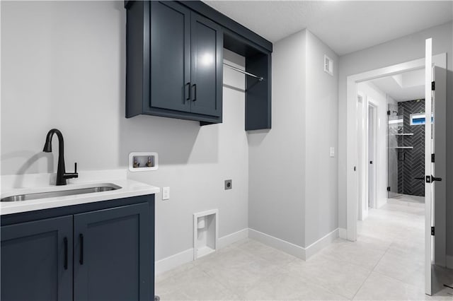 washroom featuring hookup for an electric dryer, washer hookup, a sink, baseboards, and cabinet space