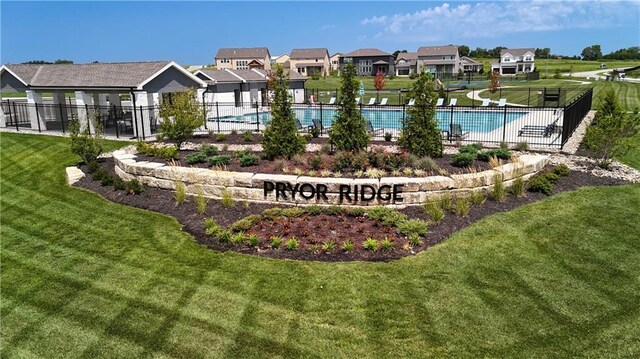 exterior space featuring a residential view, fence, and a lawn