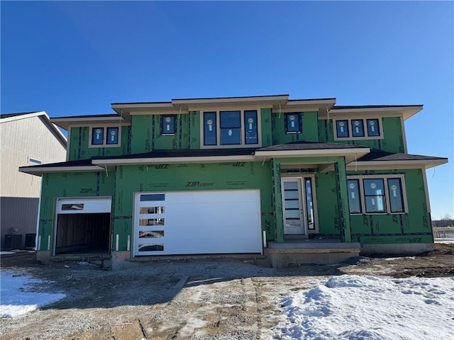 property in mid-construction with driveway, central AC, and a garage