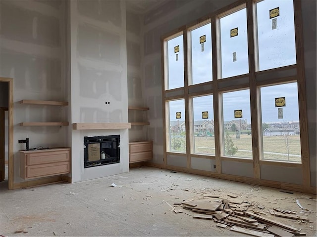 unfurnished living room with a glass covered fireplace