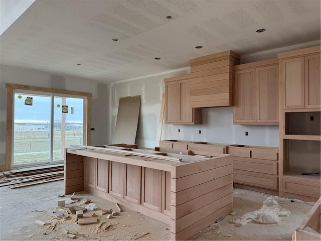 kitchen featuring light brown cabinets and a center island