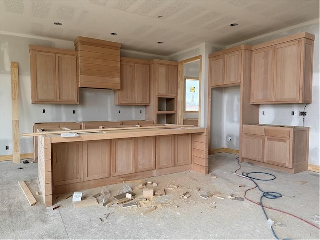 kitchen with light brown cabinets and baseboards