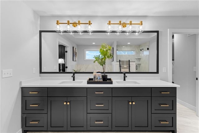 bathroom featuring a sink, marble finish floor, a shower stall, and double vanity