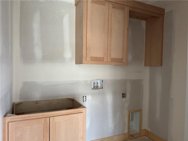 laundry area with washer hookup and cabinet space