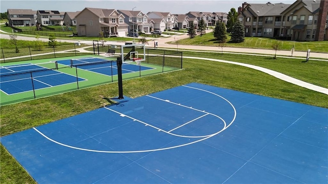 view of basketball court with community basketball court, a yard, fence, and a residential view