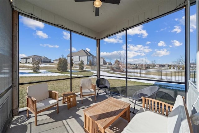 sunroom / solarium featuring ceiling fan