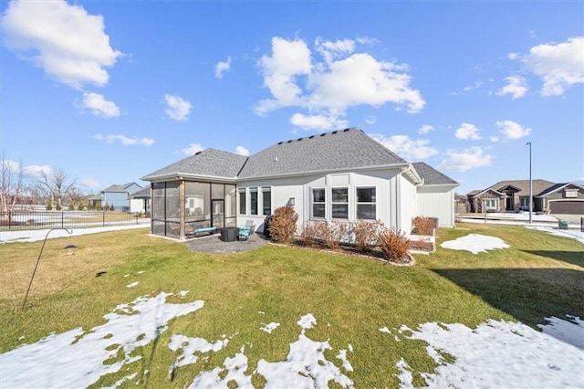 back of property featuring a yard and a sunroom