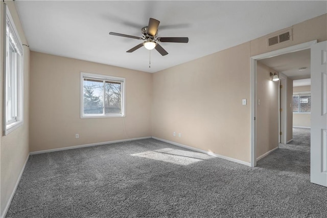 carpeted spare room with ceiling fan