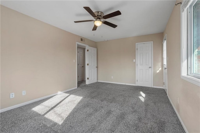 carpeted spare room with ceiling fan