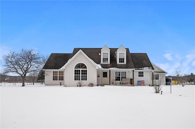 view of snow covered back of property