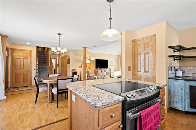 kitchen with decorative light fixtures, an inviting chandelier, light hardwood / wood-style flooring, and electric range oven