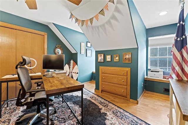 office area featuring light hardwood / wood-style floors, ceiling fan, and vaulted ceiling