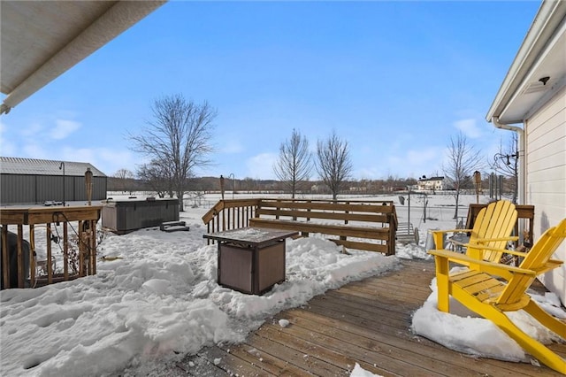 snow covered deck with a hot tub