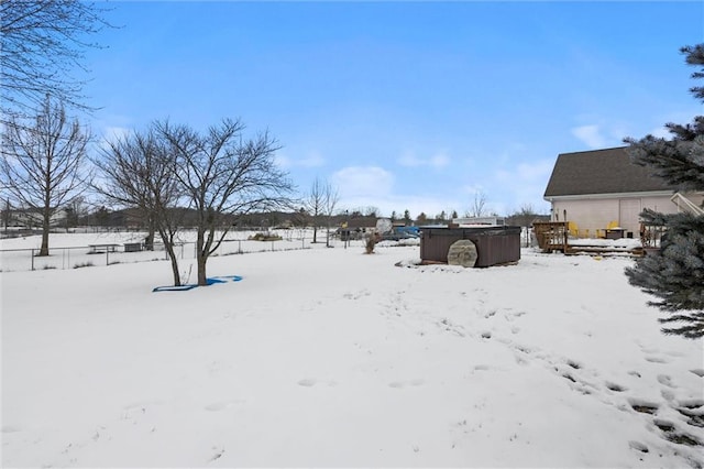 yard covered in snow featuring a jacuzzi