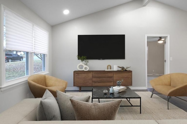 living room with ceiling fan and lofted ceiling