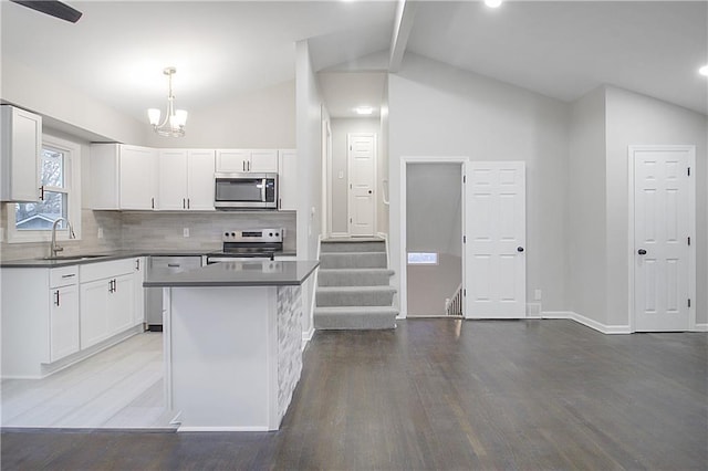 kitchen with appliances with stainless steel finishes, white cabinetry, and sink