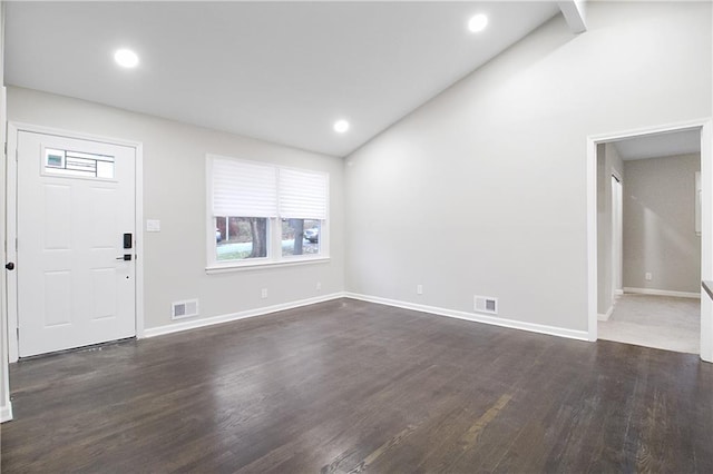 entryway featuring dark wood-type flooring and vaulted ceiling