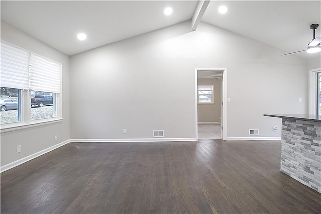 unfurnished living room with dark hardwood / wood-style flooring, vaulted ceiling with beams, a wealth of natural light, and ceiling fan