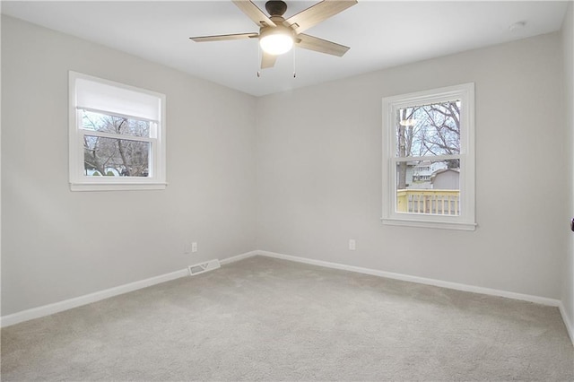 carpeted spare room with ceiling fan