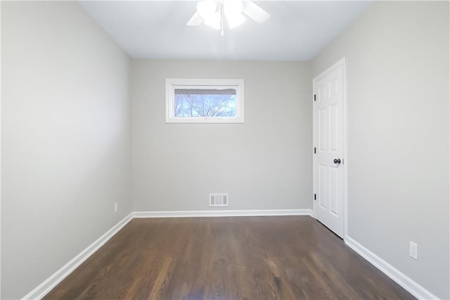 empty room with ceiling fan and dark hardwood / wood-style flooring