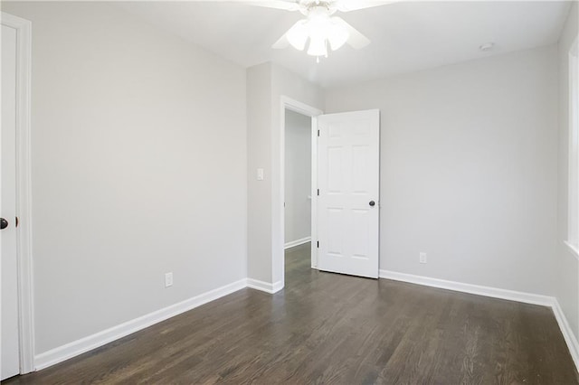 unfurnished room featuring dark hardwood / wood-style floors and ceiling fan