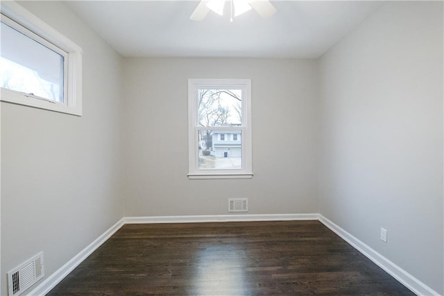 unfurnished room with ceiling fan and dark hardwood / wood-style flooring