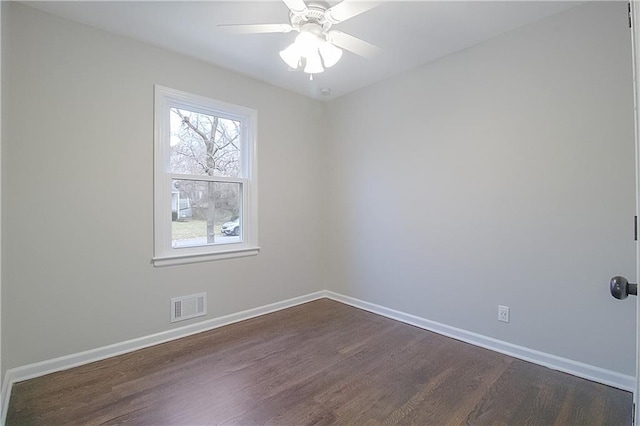 spare room with dark hardwood / wood-style floors and ceiling fan