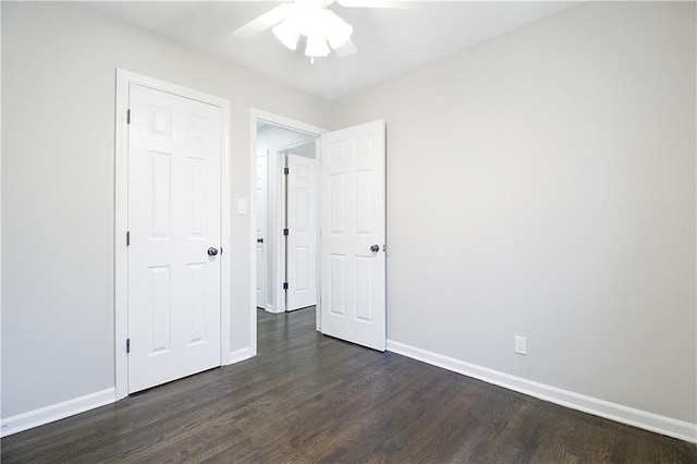 unfurnished bedroom featuring dark hardwood / wood-style flooring, a closet, and ceiling fan