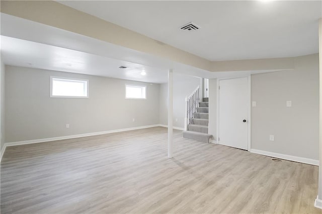 basement with light hardwood / wood-style floors