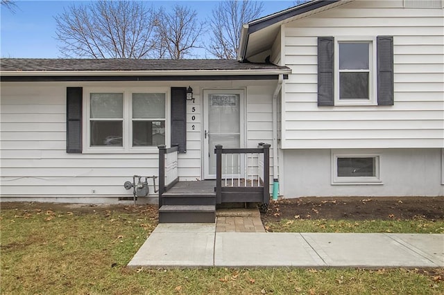 doorway to property featuring a lawn