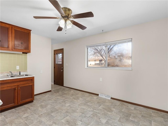 kitchen with ceiling fan and sink