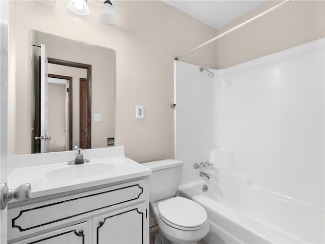 full bathroom featuring shower / bathing tub combination, vanity, and toilet