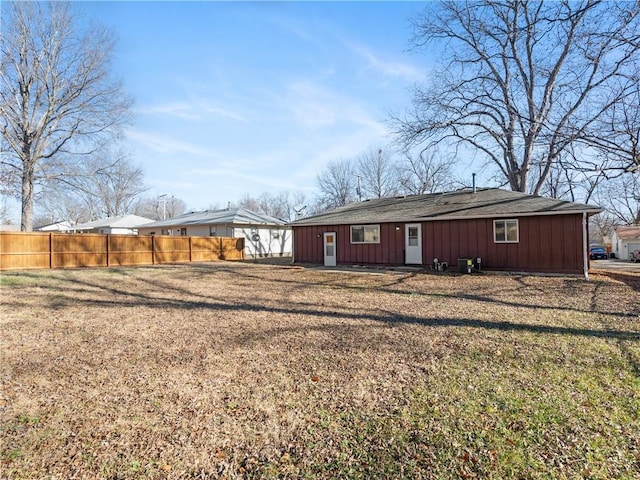 back of house with a lawn