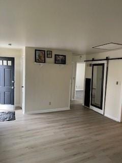 entrance foyer featuring a barn door and hardwood / wood-style floors