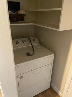 laundry room featuring dark hardwood / wood-style flooring and washer / dryer