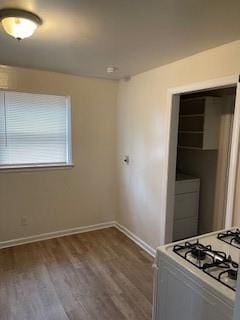 kitchen featuring white range with gas cooktop and hardwood / wood-style flooring