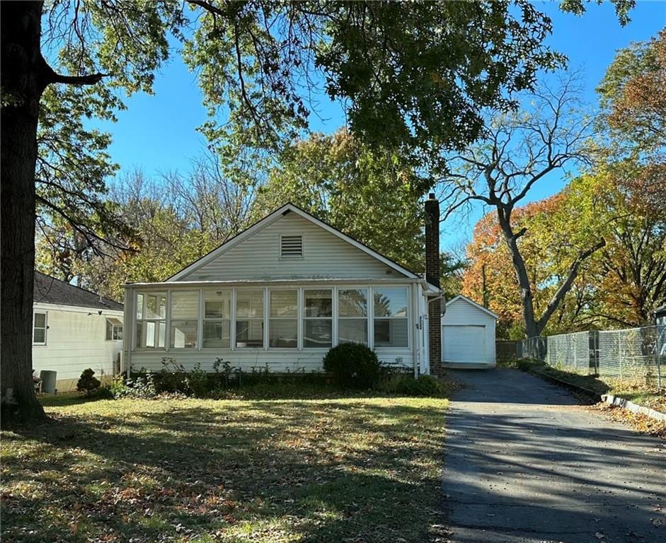 view of front of property featuring a garage and an outdoor structure