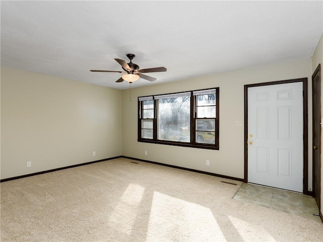 unfurnished room with ceiling fan and light carpet