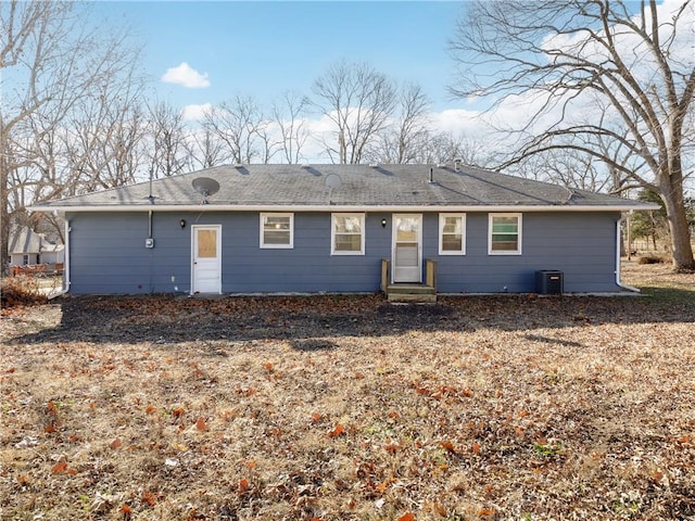 back of property featuring central AC