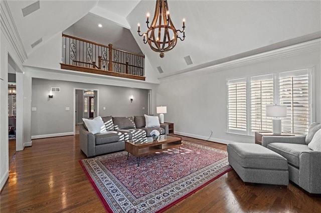 living room featuring dark hardwood / wood-style flooring, a high ceiling, and a notable chandelier