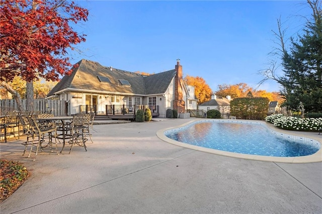 view of swimming pool with a patio area and a deck