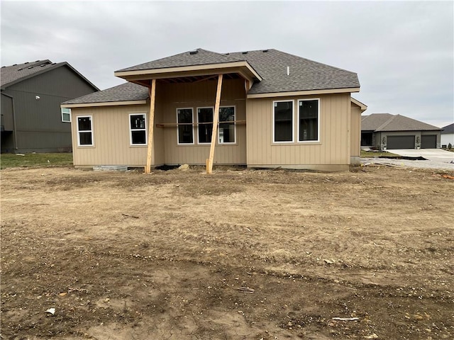 back of property with crawl space and roof with shingles