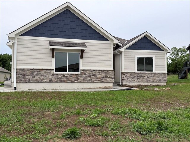 9301 SW Leviathan Ct, Lees Summit, MO 64064 - view of front facade featuring stone siding and a front yard