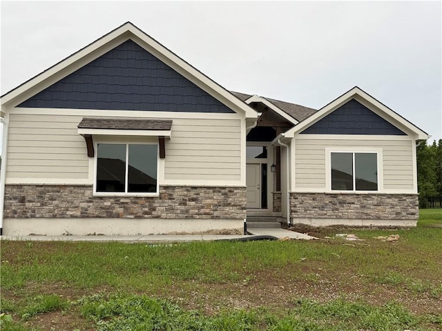 9301 SW Leviathan Ct, Lees Summit, MO 64064 - craftsman-style home featuring stone siding and a front lawn