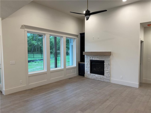9301 SW Leviathan Ct, Lees Summit, MO 64064 - unfurnished living room featuring wood finished floors, healthy amount of natural light, ceiling fan, baseboards, and a towering ceiling