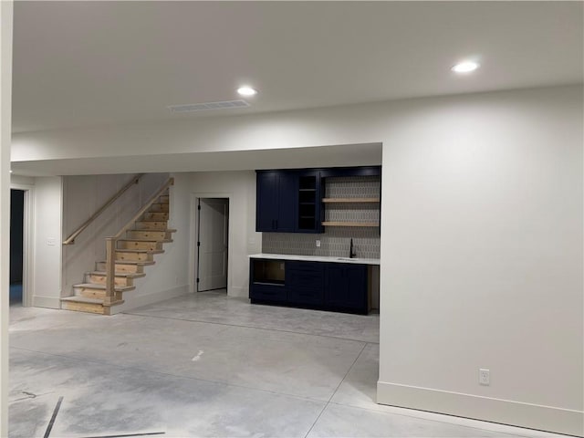 9301 SW Leviathan Ct, Lees Summit, MO 64064 - unfurnished living room featuring stairway, a sink, baseboards, recessed lighting, and concrete flooring